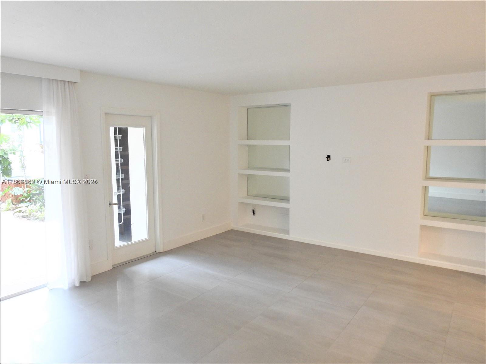 9807 Southwest 93rd Street, Unit 9807 Miami, FL 33176 - Photo 19 of 50 an empty room with closet and windows