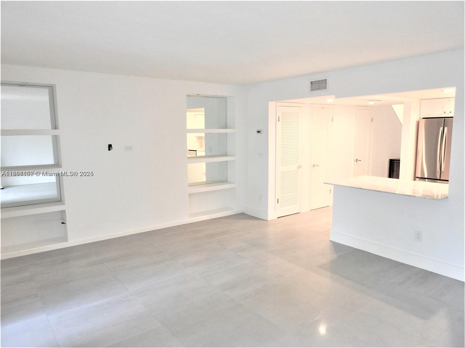 9807 Southwest 93rd Street, Unit 9807 Miami, FL 33176 - Photo 20 of 50 a view of an empty room with cabinet and a window