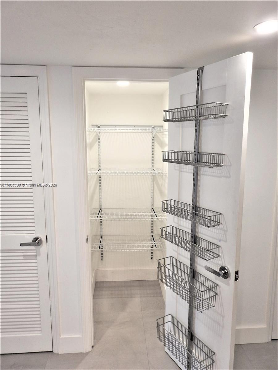 9807 Southwest 93rd Street, Unit 9807 Miami, FL 33176 - Photo 21 of 50 a view of walk in closet with empty racks