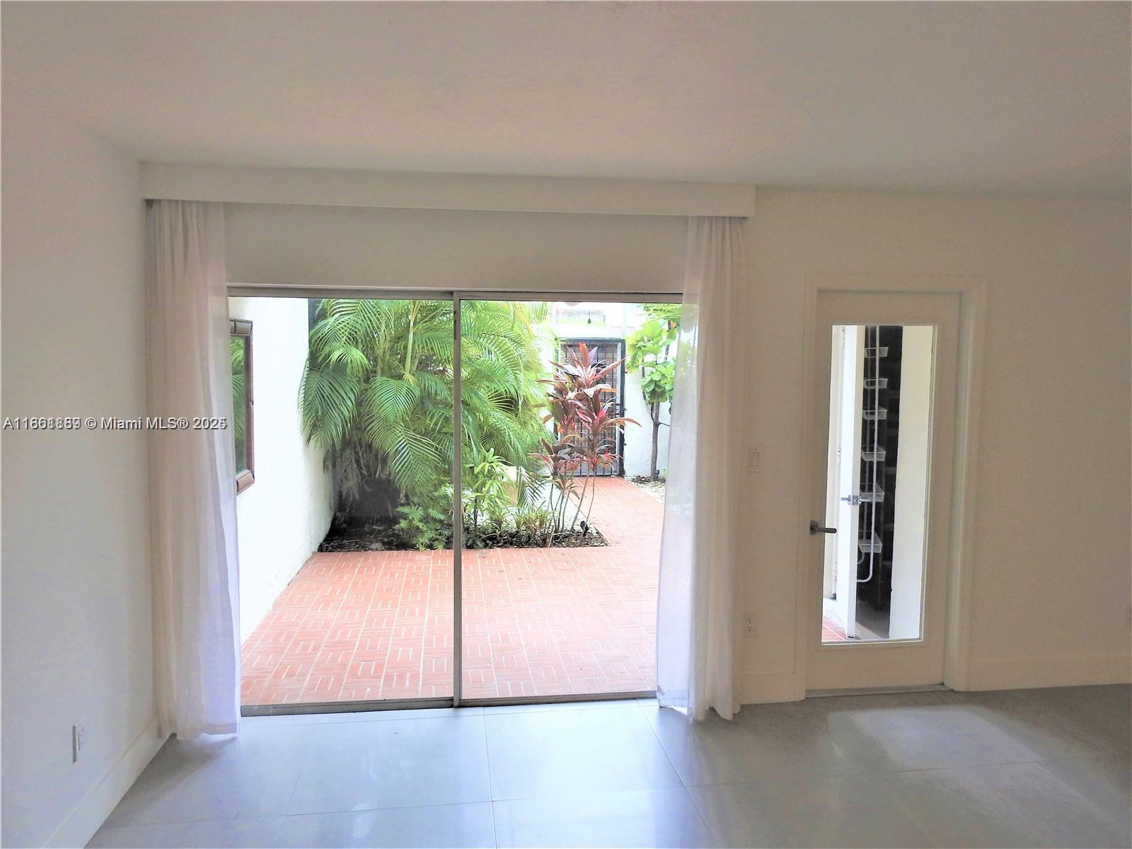 9807 Southwest 93rd Street, Unit 9807 Miami, FL 33176 - Photo 23 of 50 a view of an empty room and window