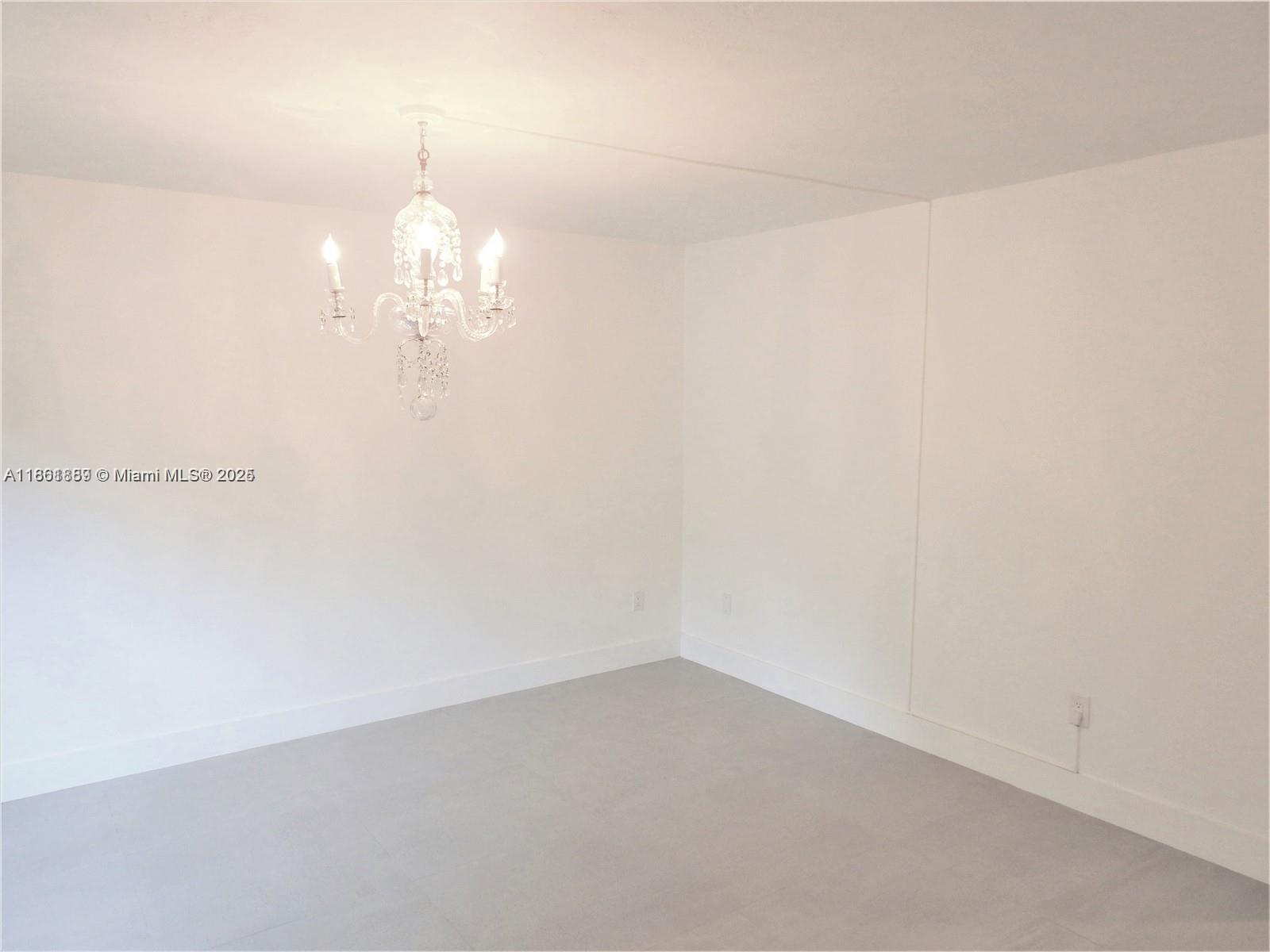 9807 Southwest 93rd Street, Unit 9807 Miami, FL 33176 - Photo 25 of 50 a view of a chandelier fan and hardwood floor