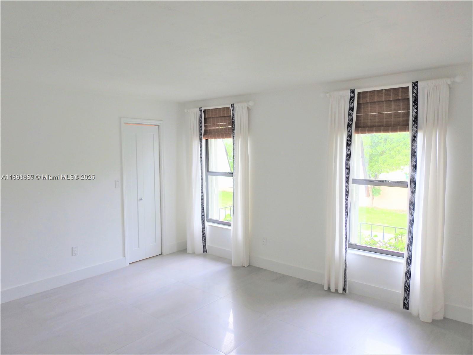 9807 Southwest 93rd Street, Unit 9807 Miami, FL 33176 - Photo 31 of 50 an empty room with windows