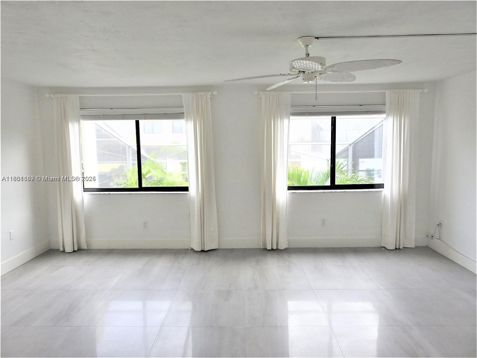 9807 Southwest 93rd Street, Unit 9807 Miami, FL 33176 - Photo 40 of 50 an empty room with windows