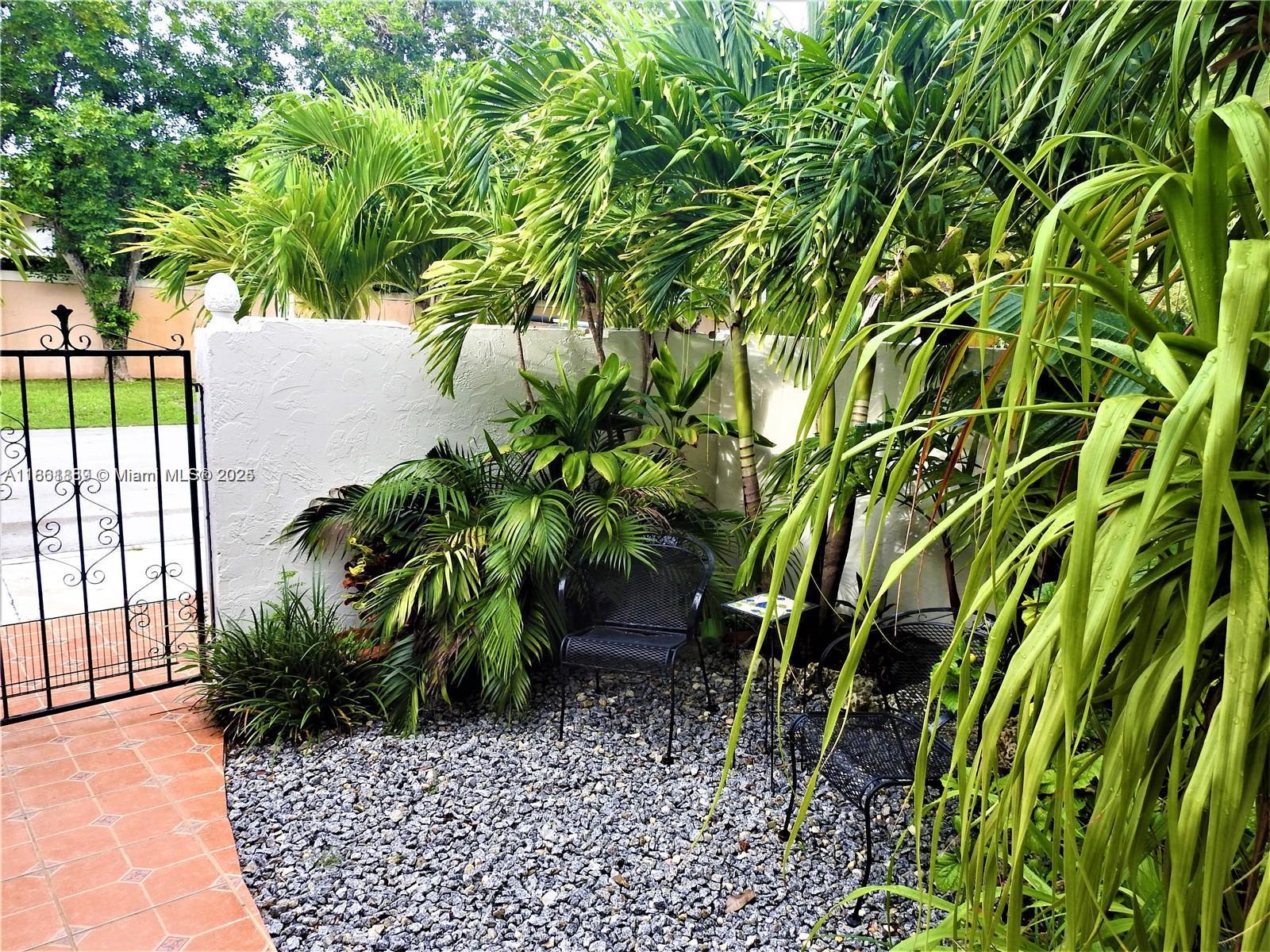 9807 Southwest 93rd Street, Unit 9807 Miami, FL 33176 - Photo 5 of 50 a view of backyard with plants and outdoor seating