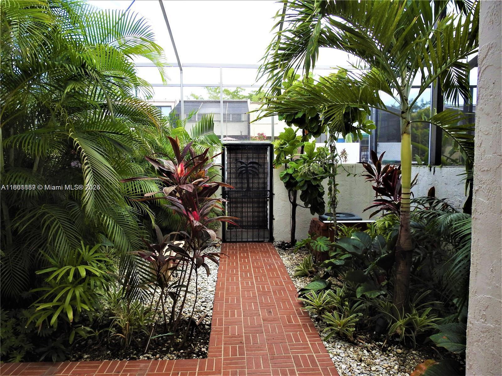 9807 Southwest 93rd Street, Unit 9807 Miami, FL 33176 - Photo 8 of 50 a backyard of a house with lots of green space