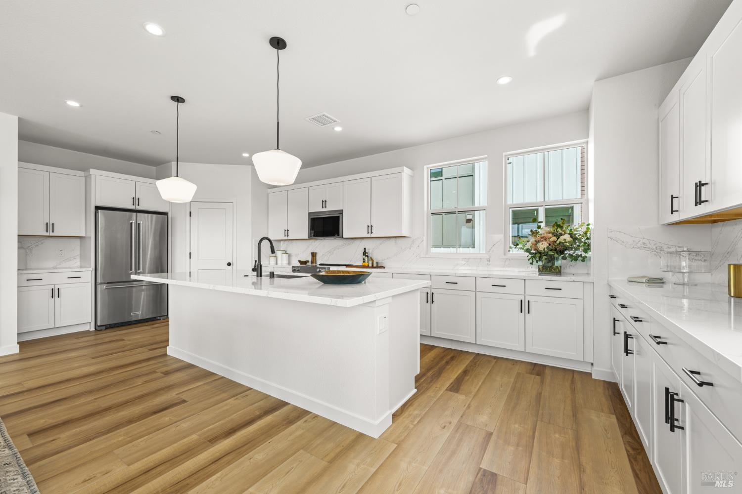 1480 Waterside Lane Rohnert Park, CA 94928 - Photo 4 of 35 a kitchen with white cabinets and white appliances