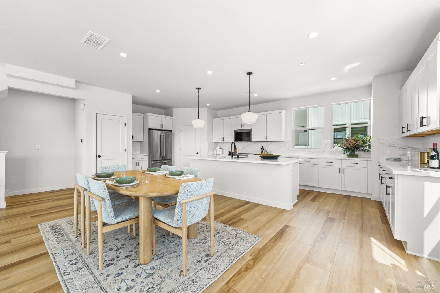 1480 Waterside Lane Rohnert Park, CA 94928 - Photo 10 of 35 a kitchen with stainless steel appliances kitchen island granite countertop a table chairs sink and cabinets