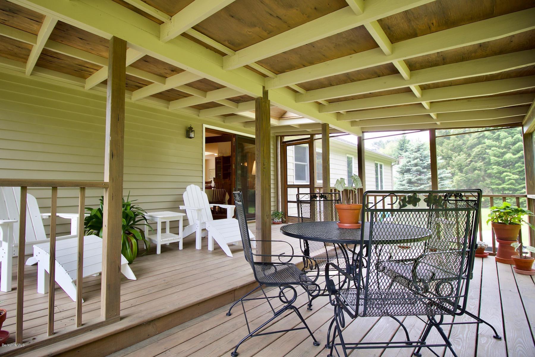 22 Old Barn Road Lenox, MA 01240 - Photo 14 of 37 a view of a patio with table and chairs and wooden floor