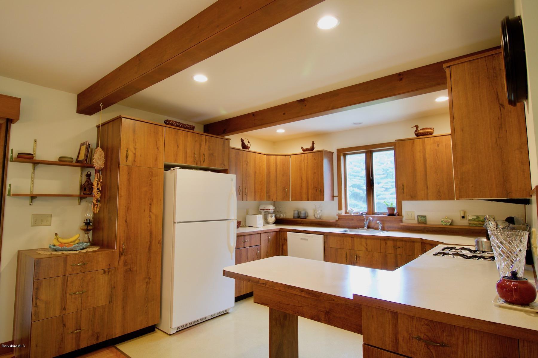 22 Old Barn Road Lenox, MA 01240 - Photo 20 of 37 a kitchen with a refrigerator a sink and cabinets