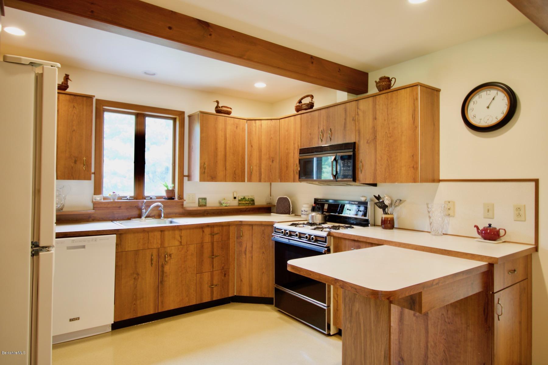 22 Old Barn Road Lenox, MA 01240 - Photo 21 of 37 a kitchen with a sink a stove and cabinets