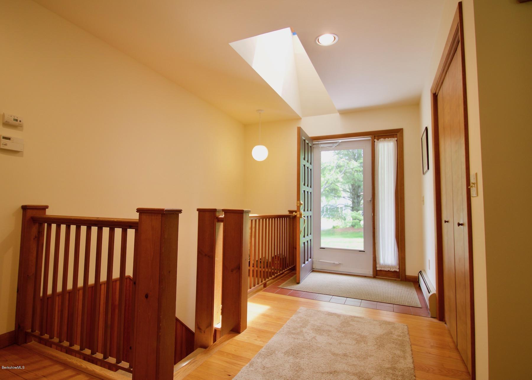 22 Old Barn Road Lenox, MA 01240 - Photo 25 of 37 a view of a hallway with wooden floor and staircase