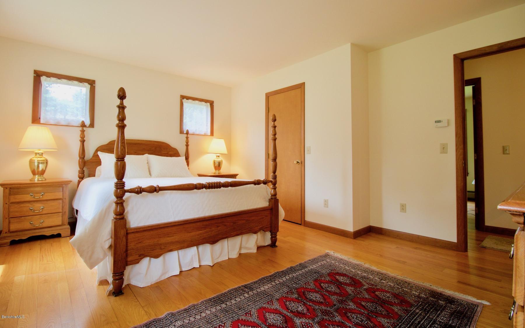 22 Old Barn Road Lenox, MA 01240 - Photo 30 of 37 a bedroom with a bed and wooden floor