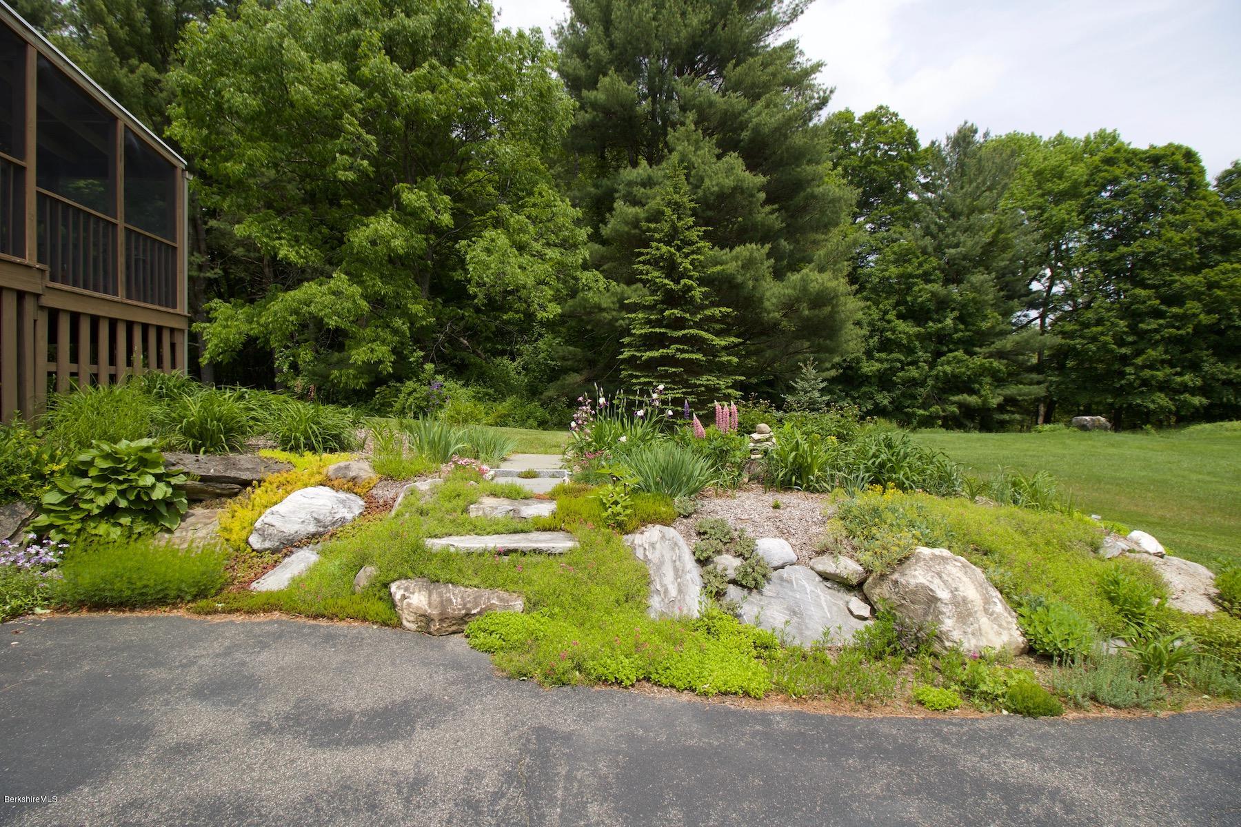22 Old Barn Road Lenox, MA 01240 - Photo 10 of 37 a backyard of a house with yard and outdoor seating