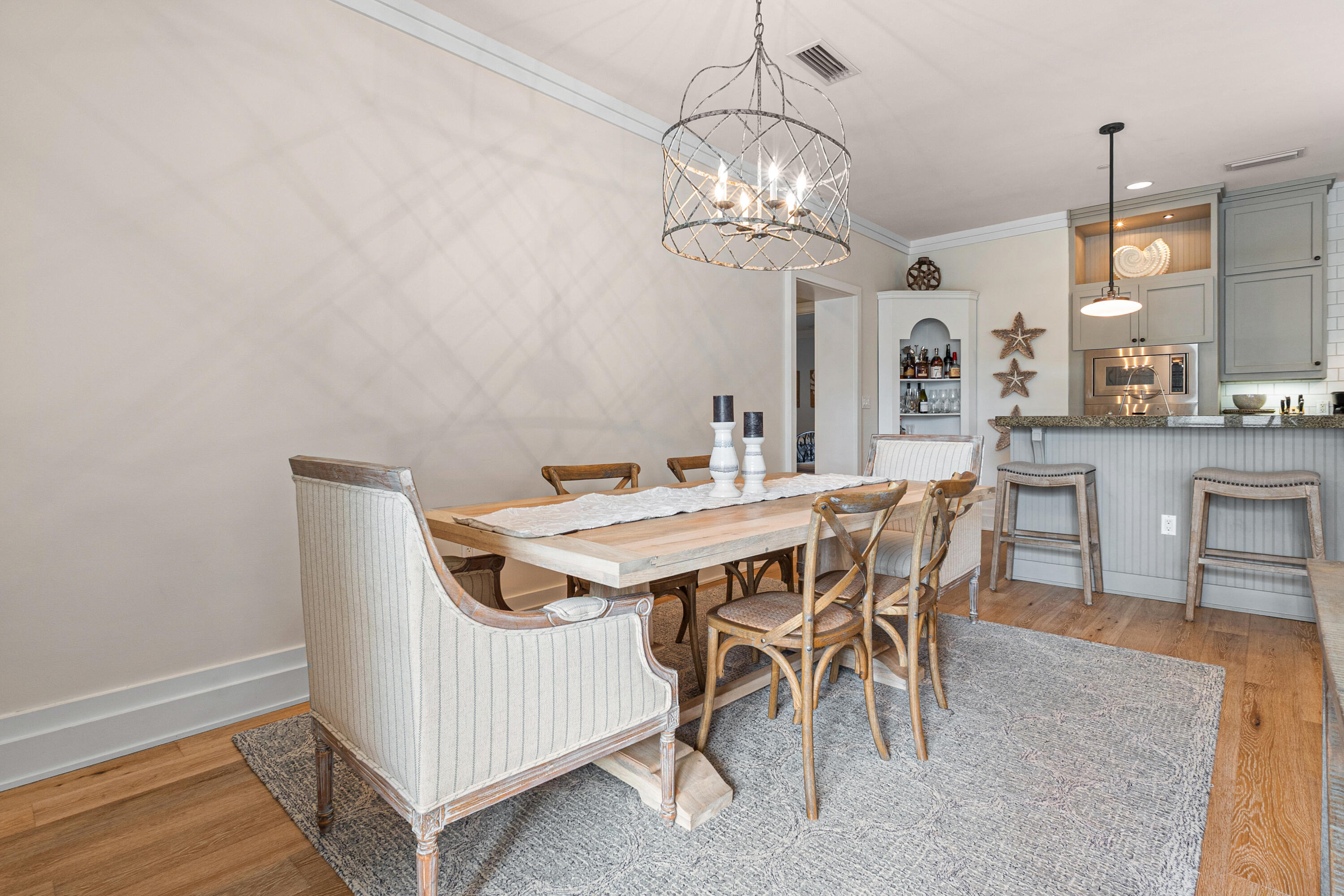 8377 East County Highway 30A, Unit 103 Inlet Beach, FL 32461 - Photo 12 of 36 a view of a dining room with furniture and chandelier
