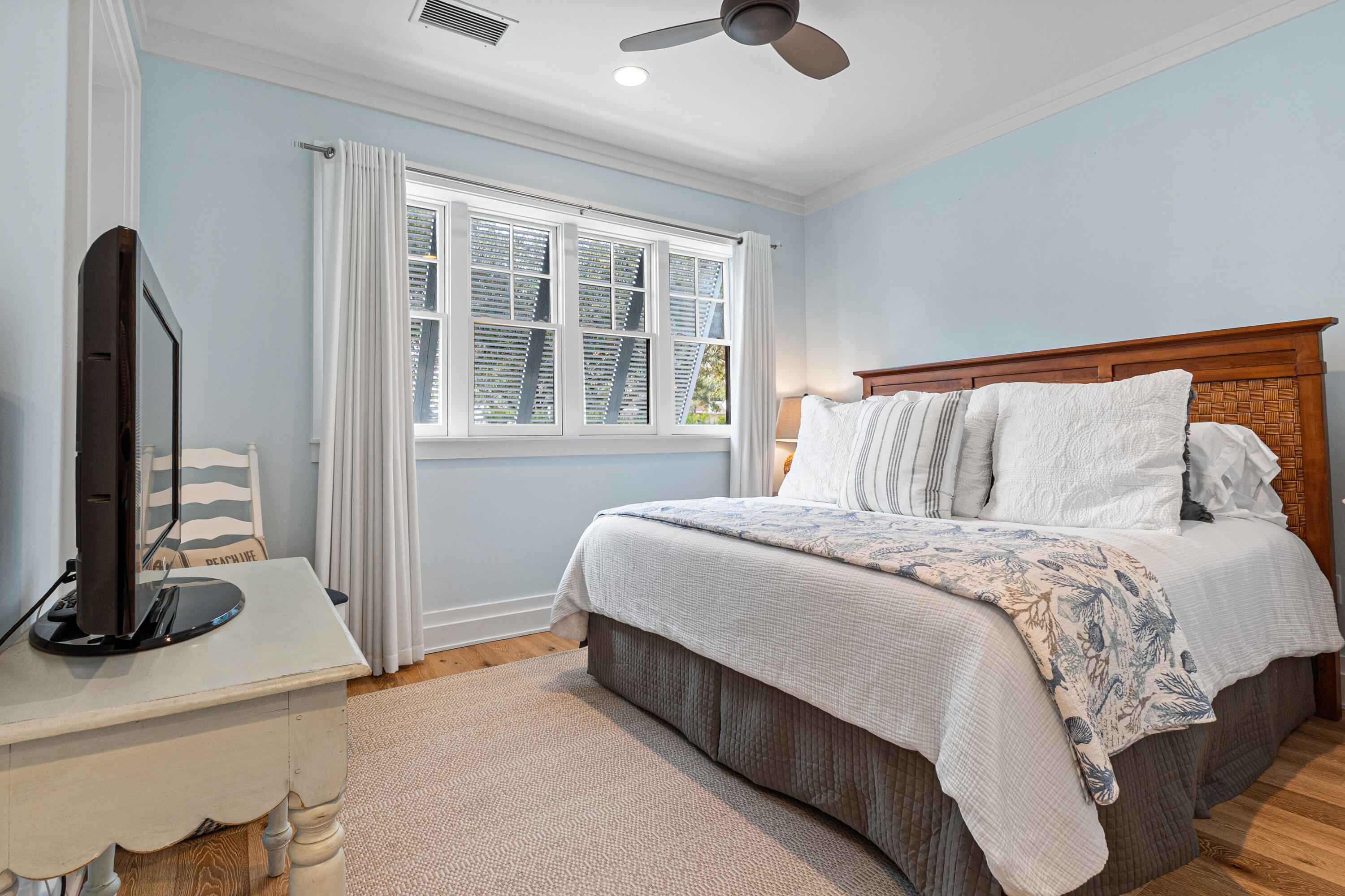 8377 East County Highway 30A, Unit 103 Inlet Beach, FL 32461 - Photo 18 of 36 a bedroom with a bed and a flat tv screen on a dresser