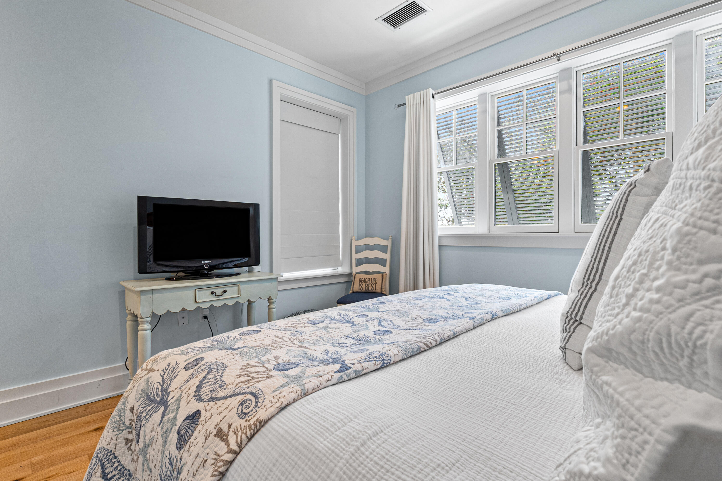 8377 East County Highway 30A, Unit 103 Inlet Beach, FL 32461 - Photo 19 of 36 a bedroom with a bed and a flat screen tv