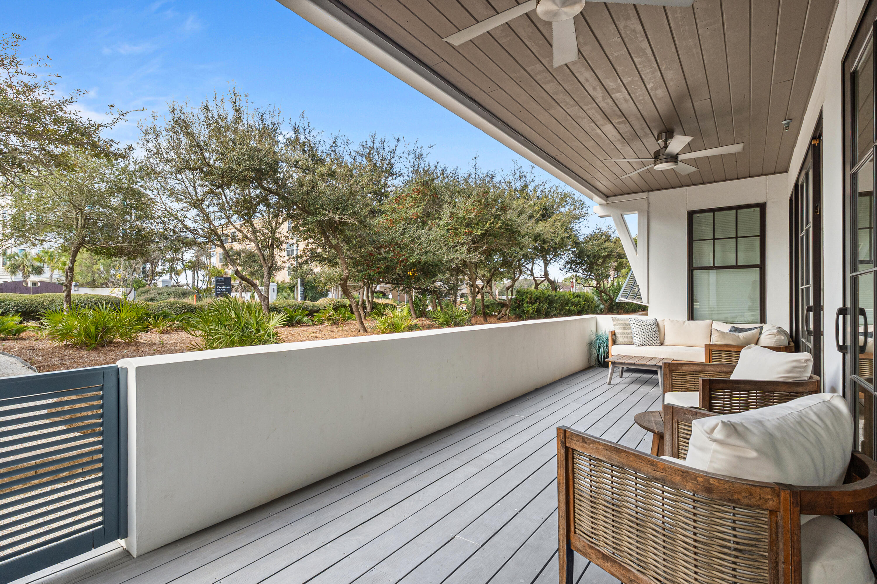 8377 East County Highway 30A, Unit 103 Inlet Beach, FL 32461 - Photo 2 of 36 a balcony with couple of couches and wooden fence