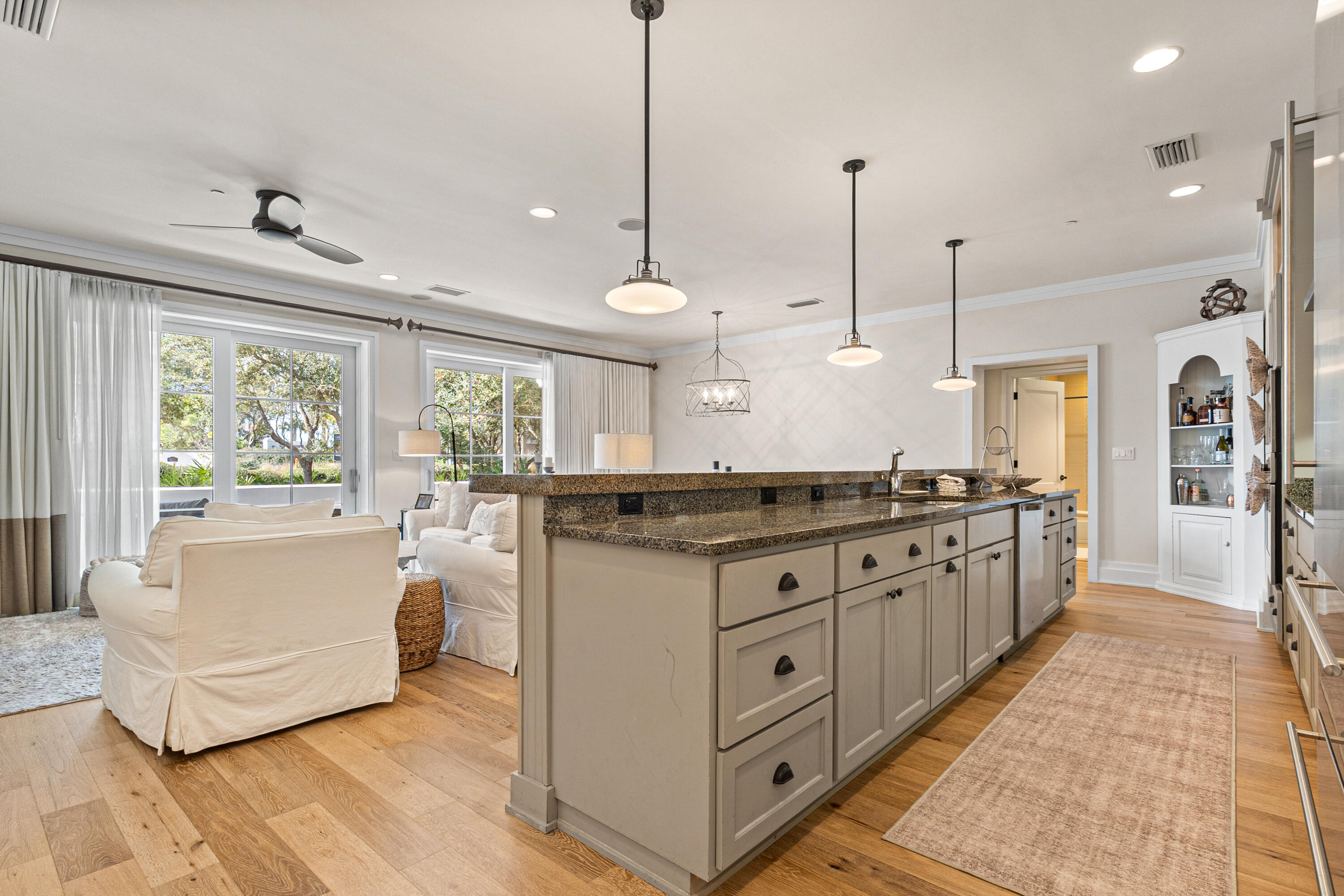 8377 East County Highway 30A, Unit 103 Inlet Beach, FL 32461 - Photo 4 of 36 a large kitchen with kitchen island granite countertop a stove a sink a center island a refrigerator and a view of living room