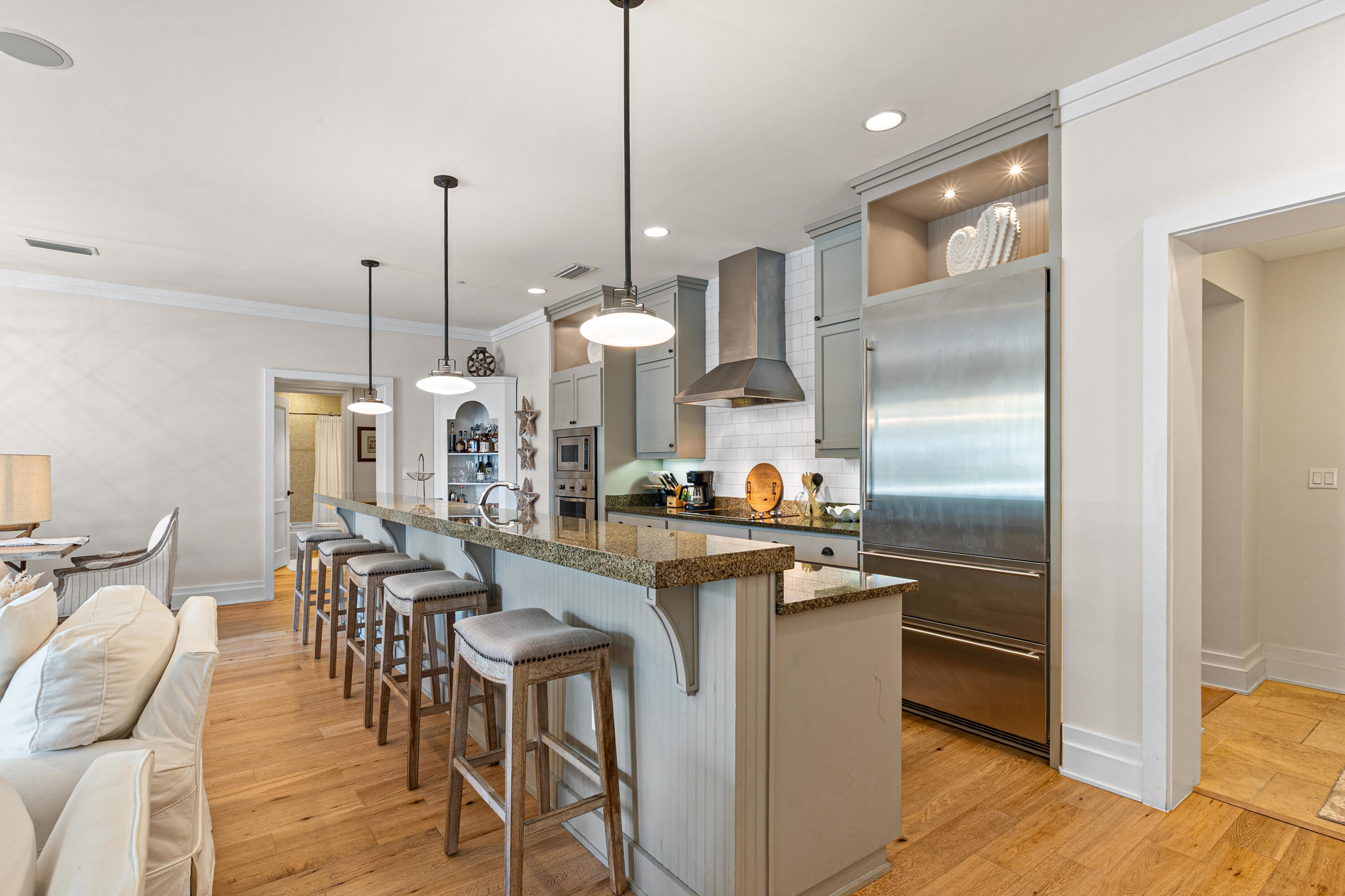 8377 East County Highway 30A, Unit 103 Inlet Beach, FL 32461 - Photo 5 of 36 a kitchen with stainless steel appliances a dining table chairs a sink and dishwasher