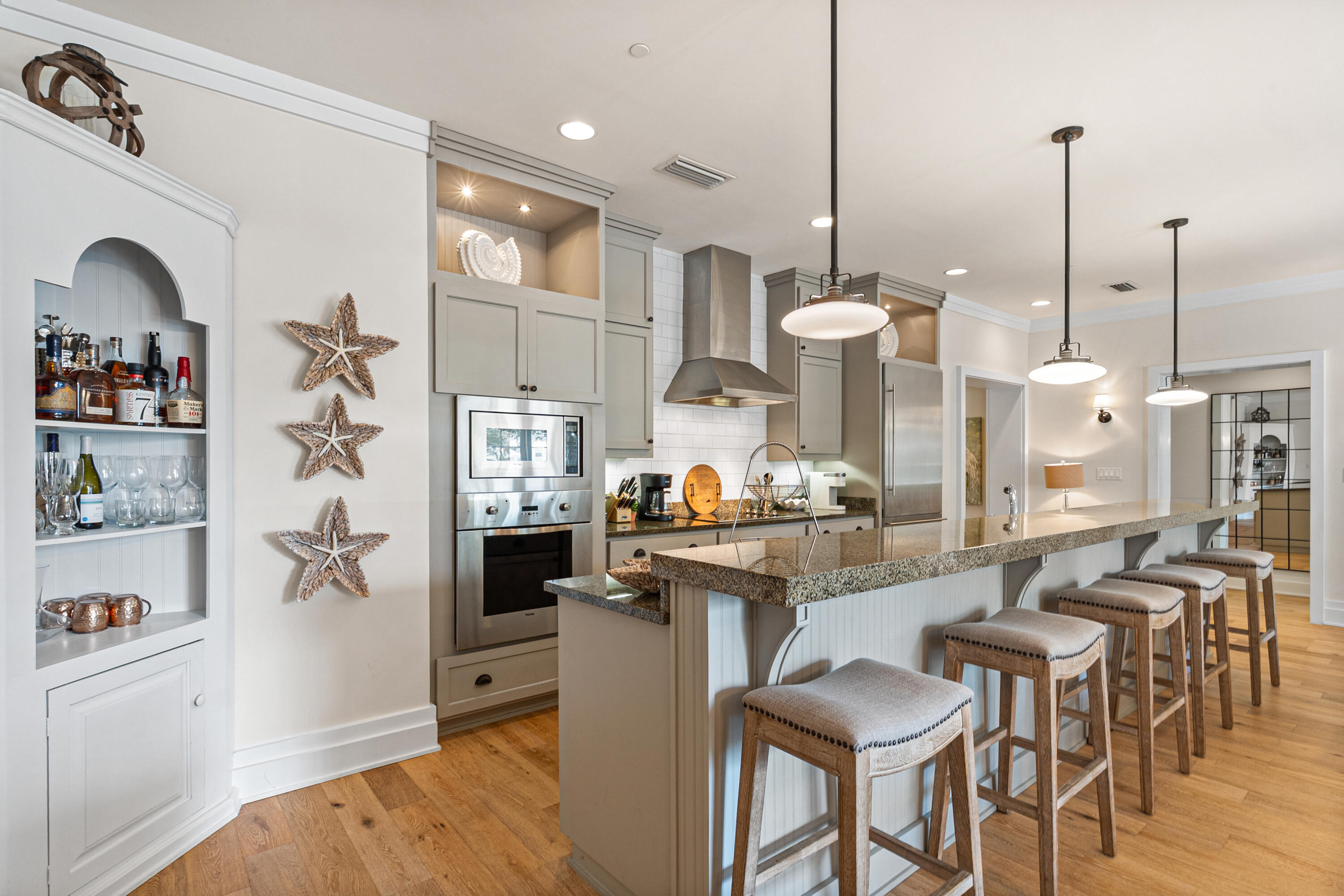 8377 East County Highway 30A, Unit 103 Inlet Beach, FL 32461 - Photo 6 of 36 a kitchen with stainless steel appliances granite countertop a refrigerator a stove and a wooden floors