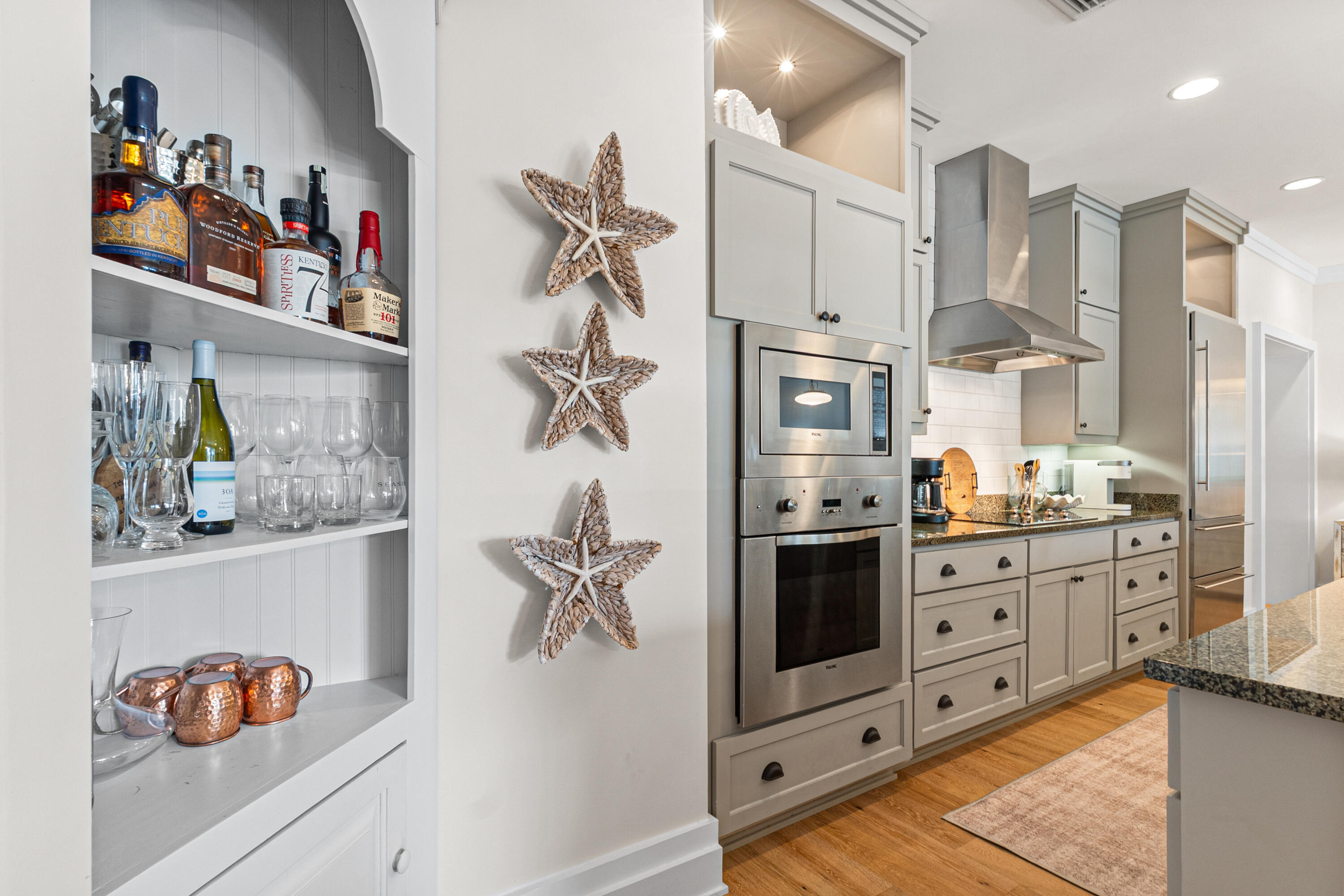 8377 East County Highway 30A, Unit 103 Inlet Beach, FL 32461 - Photo 7 of 36 a kitchen with stainless steel appliances kitchen island granite countertop a refrigerator and a stove top oven