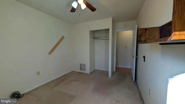 a view of a livingroom with a ceiling fan and window