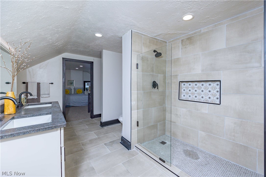 3254 Redwood Road Cleveland Heights, OH 44118 - Photo 26 of 49 Bathroom with toilet, a textured ceiling, a shower with shower door, and double sink vanity