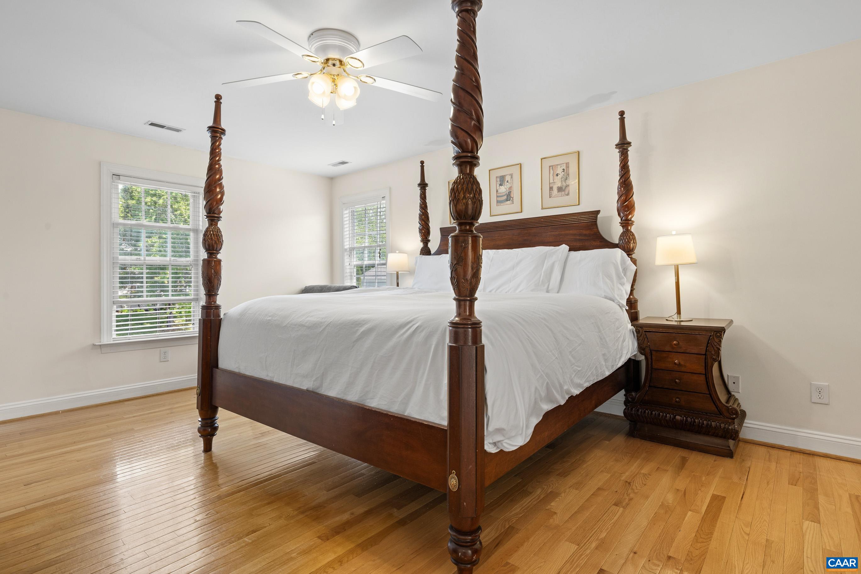 1236 Amber Ridge Road Charlottesville, VA 22901 - Photo 26 of 56 a bedroom with a bed and a chandelier