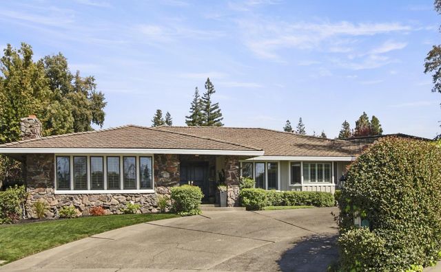 a front view of a house with garden
