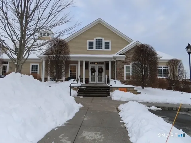 a view of a house with a yard and sitting area