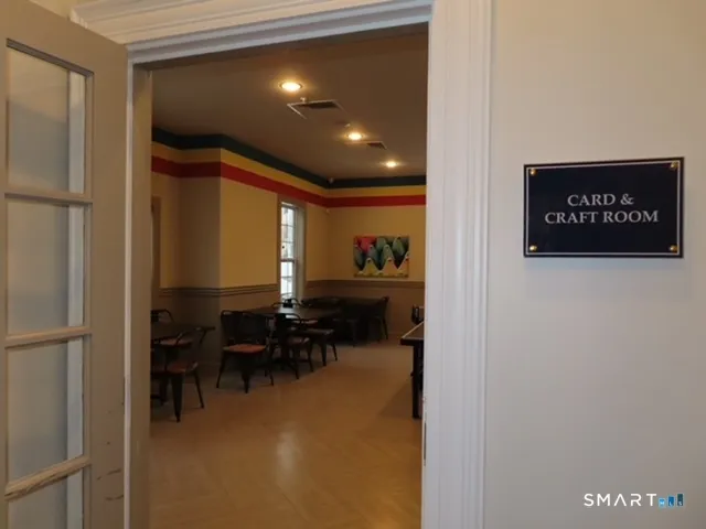 a view of dining room with furniture and a chandelier