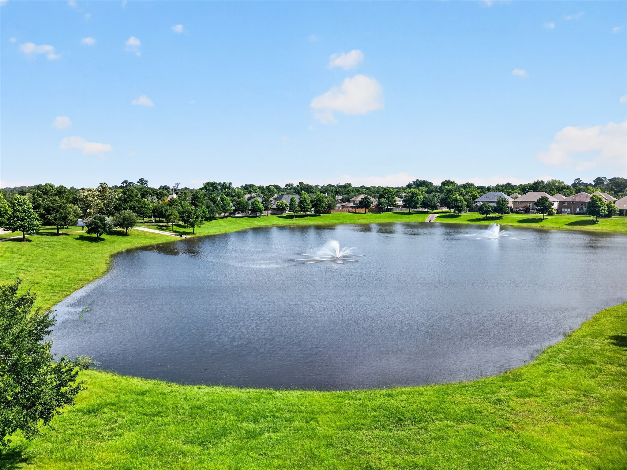 18202 Wedgewood Bluff Court Spring, TX 77379 - Photo 49 of 50 Community pond view with fountain and surrounding green space.