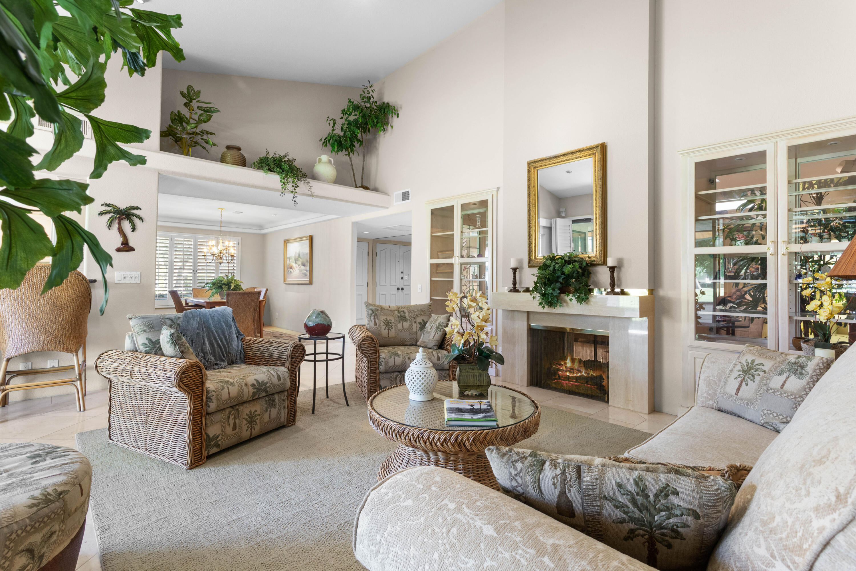 a living room with furniture large window and a fireplace