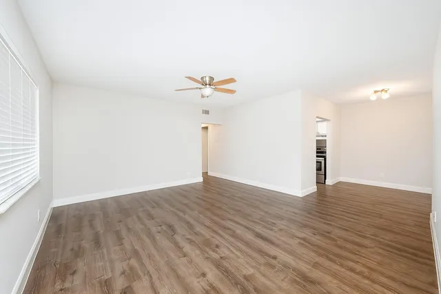 a view of a room with wooden floor