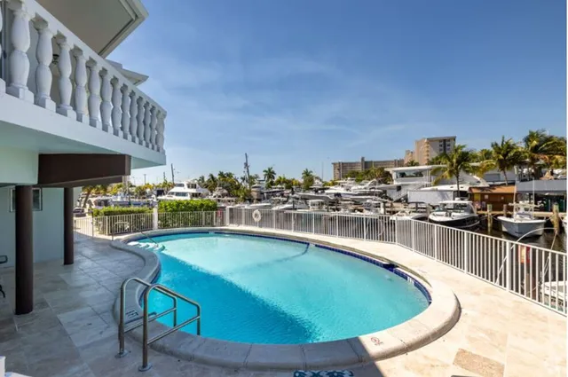 a view of a swimming pool with outdoor seating