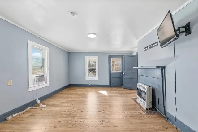 a view of livingroom with hardwood floor and a fireplace