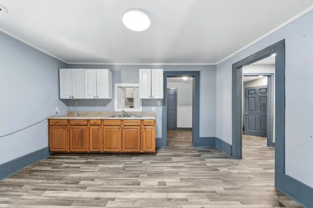 a kitchen with stainless steel appliances granite countertop a refrigerator and a stove top oven