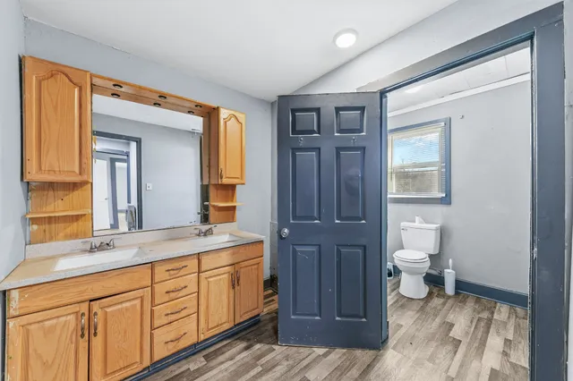 a spacious bathroom with a granite countertop sink and a mirror