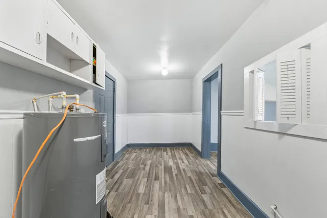 a view of a hallway view with wooden floor and staircase