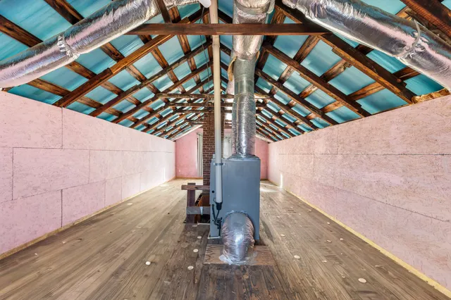 a backyard of a house with wooden floor and outdoor seating