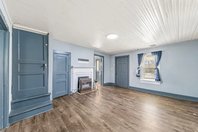 an empty room with windows and cabinet