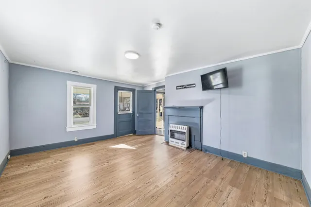 a view of a livingroom with a fireplace and a window