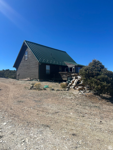 19075 West Honesty Cove Duchesne, UT 84021 - Photo 31 of 44 Log cabin style home featuring a green metal roof