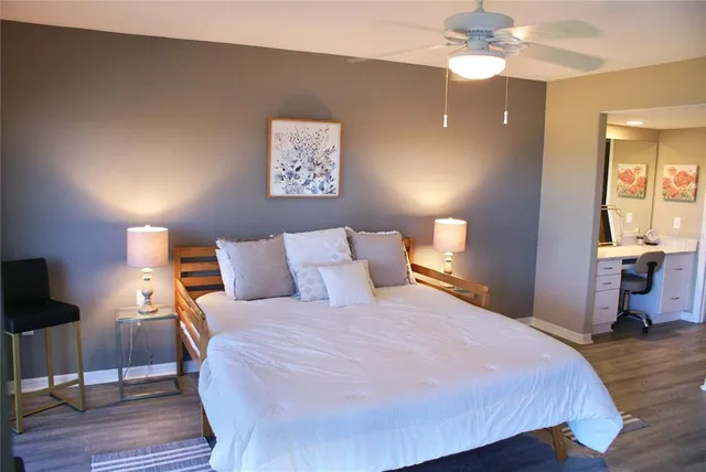 a bedroom with a bed and a large window