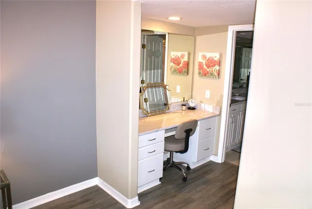 a spacious bathroom with a sink a toilet and a mirror