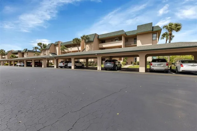 a view of building with cars parked