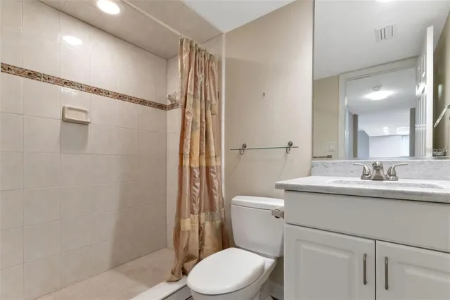 a bathroom with a toilet a sink and a shower