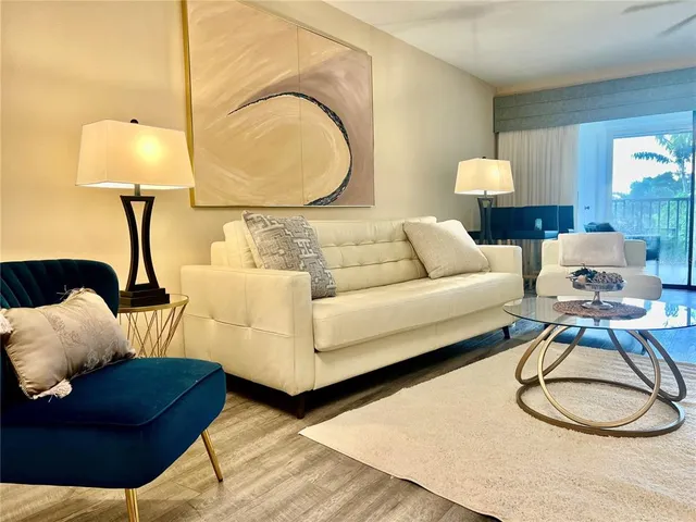 a living room with furniture a lamp and a lamp