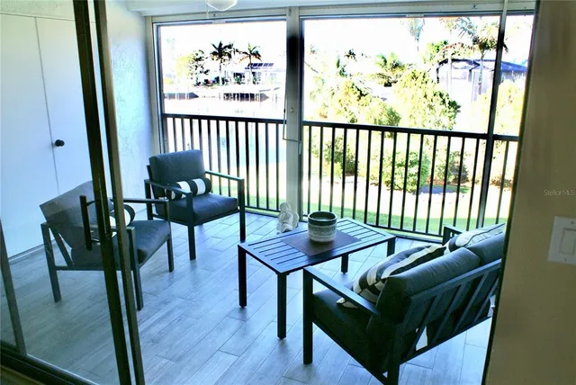a view of a chairs and table in a balcony