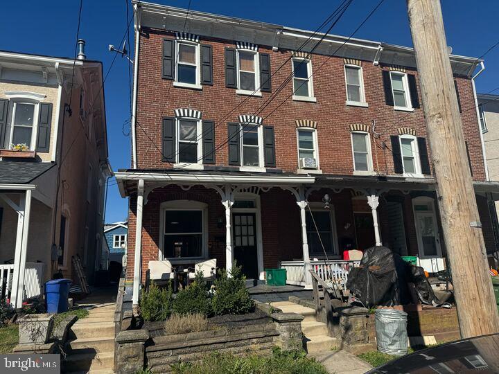 a front view of a building with sitting area